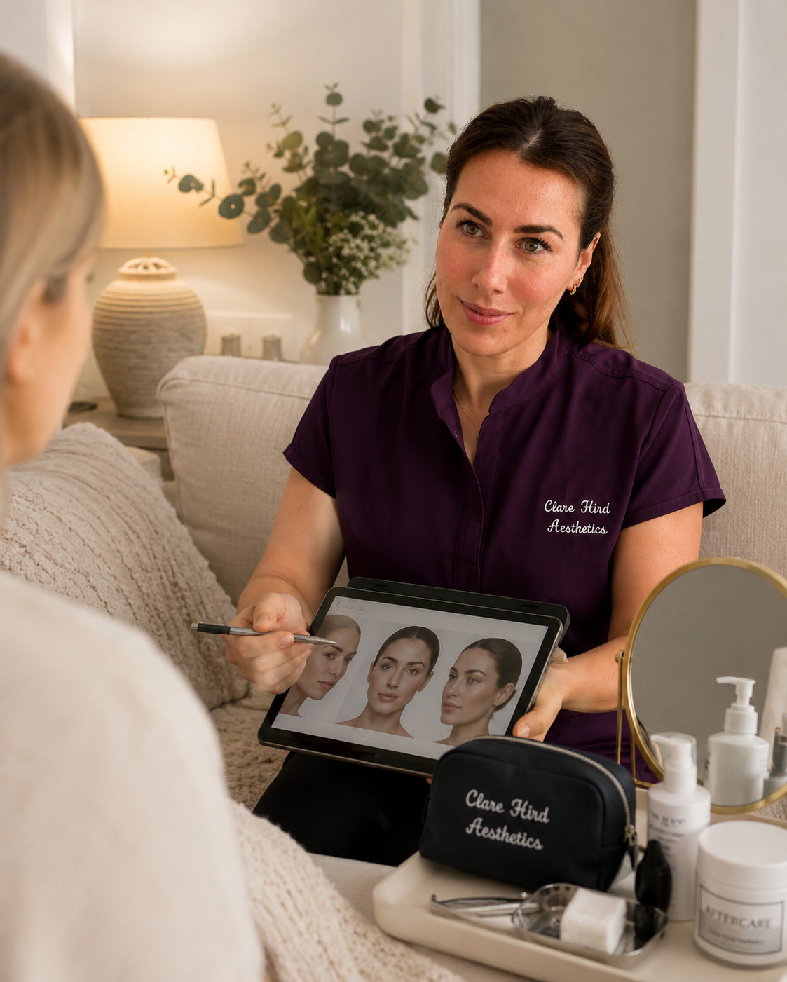 Clare Hird conducting an aesthetic consultation with a client, reviewing facial analysis on a tablet